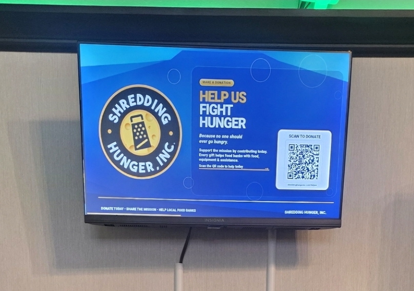 Community advertising campaign displayed on a venue monitor